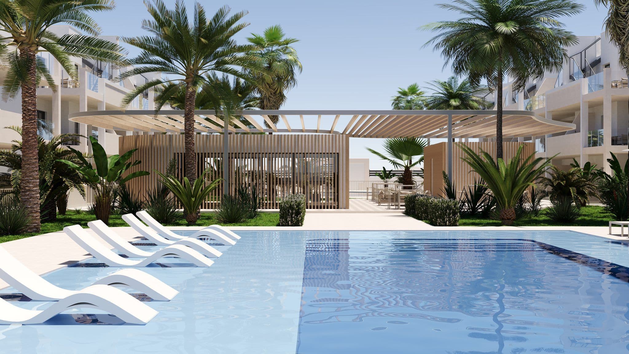 Zonovergoten zwembad met ligbedden en palmbomen in appartementencomplex San Cayetano.
