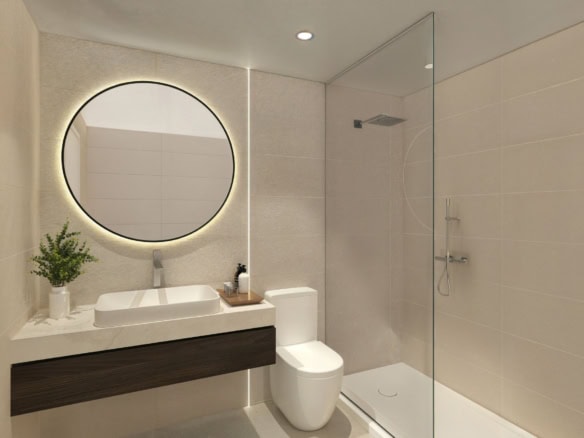Moderne badkamer met wastafel, spiegel en toilet in bungalowappartement.