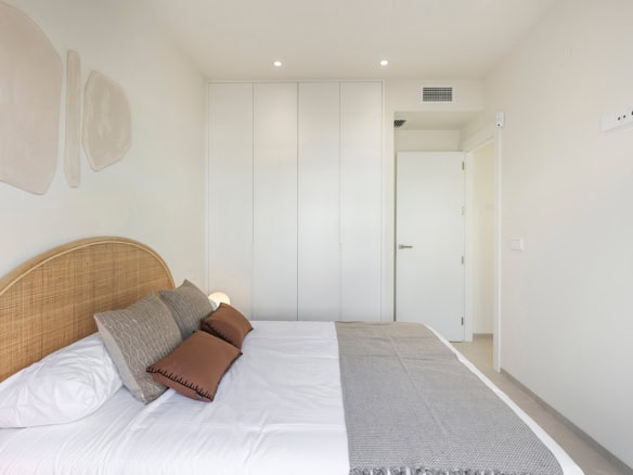 Moderne slaapkamer in villa aan Serena Golf, met wit interieur en comfortabele bedden.